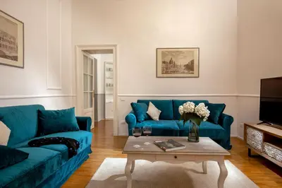 a living room with two blue couches and a coffee table at Daplace - Virginia Apartment in Rome