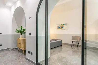 a room with a bed and a glass wall at Laurina deluxe apartment in Rome