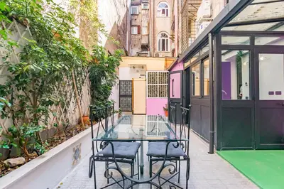 a glass table and chairs on a sidewalk next to a building at Laurina deluxe apartment in Rome