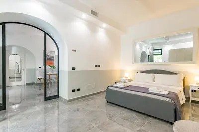 a bedroom with a bed and a large mirror at Laurina deluxe apartment in Rome