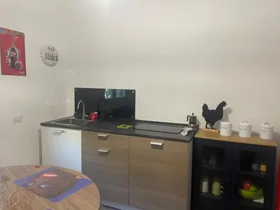 a kitchen with a stove and a counter with a cat on it at CHEZ NOUS in Rome