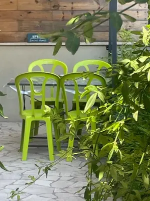 two green chairs sitting next to a table at CHEZ NOUS in Rome