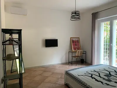 a bedroom with a bed and a tv on a wall at CHEZ NOUS in Rome