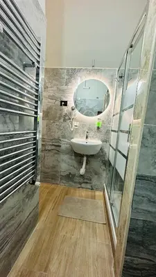 a bathroom with a sink and a mirror at Soha's Holiday in Rome