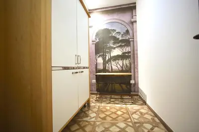 a hallway with a kitchen with a painting on the wall at Monti Holiday House in Rome