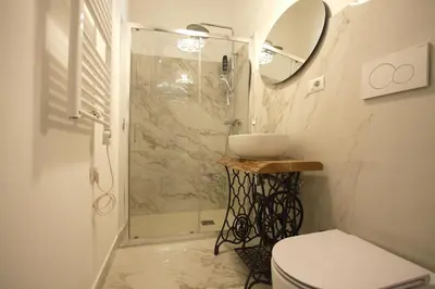 a bathroom with a shower and a toilet and a sink at Monti Holiday House in Rome