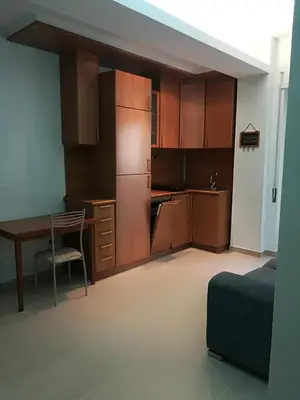 a small kitchen with a table and a desk at TEMPORARY HOME ROMA in Rome