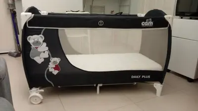 a small crib with two mice on it in a room at TEMPORARY HOME ROMA in Rome