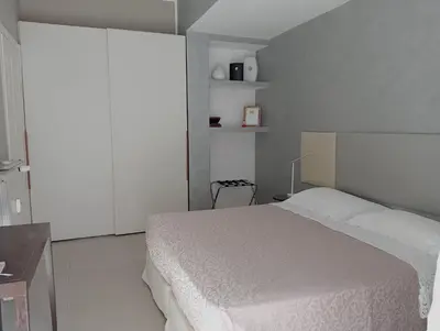 a bedroom with a white bed in a room at TEMPORARY HOME ROMA in Rome