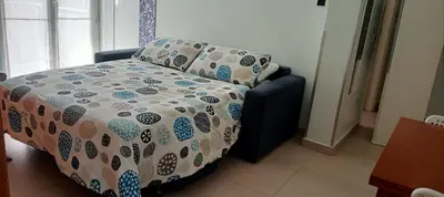 a bed with a comforter and pillows in a room at TEMPORARY HOME ROMA in Rome