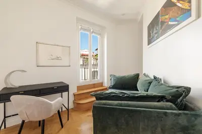 a living room with a green couch and a desk at Casa Colonna, a Burghesius home in Rome