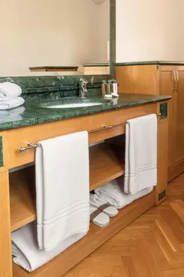 a bathroom with a sink and a counter with towels at Casa Colonna, a Burghesius home in Rome