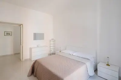a white bedroom with a bed and white walls at Luminoso vicino Piazzale Flaminio e Roma centro in Rome