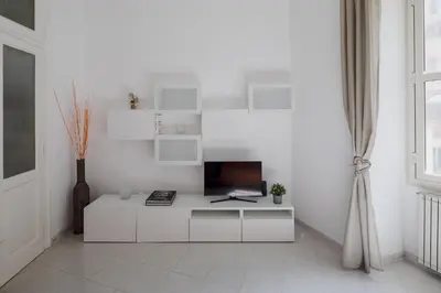 a white room with a desk with a television at Luminoso vicino Piazzale Flaminio e Roma centro in Rome