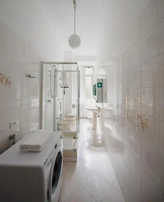 a white bathroom with a washing machine in it at Luminoso vicino Piazzale Flaminio e Roma centro in Rome