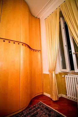 a corner of a room with a curtain and a window at Aldebaran in Rome
