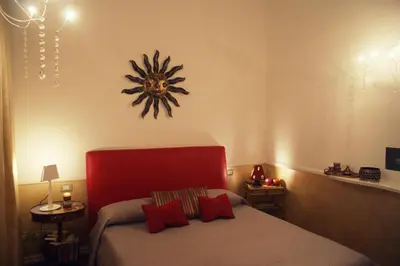 a bedroom with a bed and a clock on the wall at Aldebaran in Rome