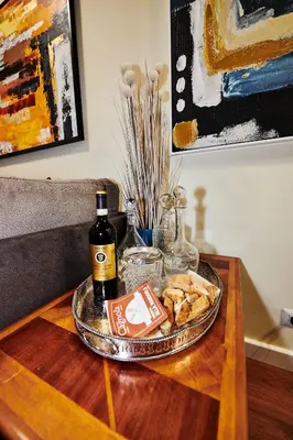 a table with a plate of food and a bottle of wine at Vatican luxury - private parking free - meospiti luxury in Rome