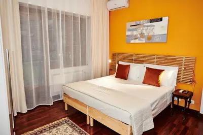 a bedroom with a large bed with yellow walls at Vatican luxury - private parking free - meospiti luxury in Rome