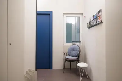 a room with a blue door and a chair at Maison Ammiragli Vatican Rooms in Rome