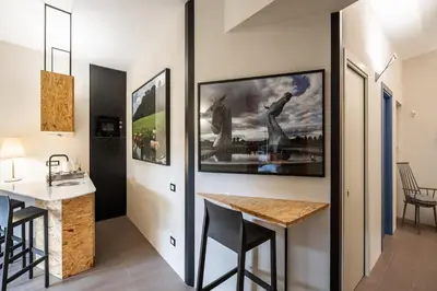 a kitchen with a counter and a table in a room at Maison Ammiragli Vatican Rooms in Rome