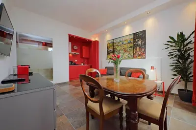 a kitchen and dining room with a wooden table and chairs at suity I monkeys apartment in Rome