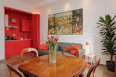 a dining room table with a vase of flowers on it at suity I monkeys apartment in Rome
