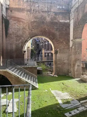 an old building with a bridge and an arch way at Over the Roman ruins in Rome