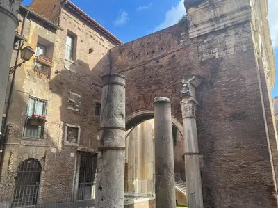 an old brick building with two pillars in front of it at Over the Roman ruins in Rome