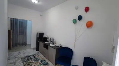 a living room with a white wall with a balloon at VATICAN GREEN GARDEN in Rome
