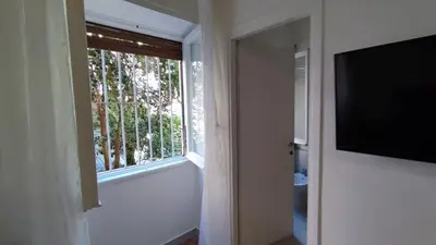 a room with a window and a flat screen tv at VATICAN GREEN GARDEN in Rome