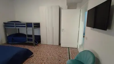 a bedroom with two bunk beds and a television at VATICAN GREEN GARDEN in Rome