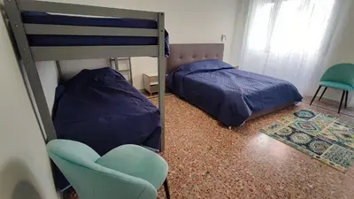a bedroom with a bunk bed and a chair at VATICAN GREEN GARDEN in Rome