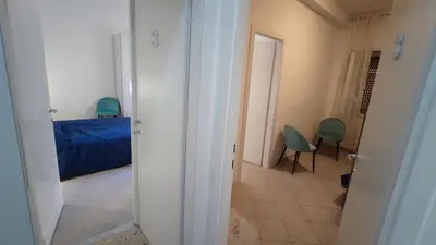 a hallway with a bed and chairs in a room at VATICAN GREEN GARDEN in Rome