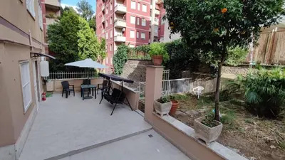 a patio with a table and chairs and an umbrella at VATICAN GREEN GARDEN in Rome