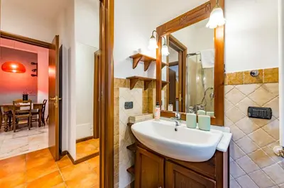 a bathroom with a sink and a mirror at Alle Mura Aurelie Apartment in Rome