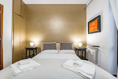 a bedroom with a large bed with towels on it at Alle Mura Aurelie Apartment in Rome