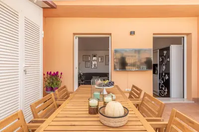 a dining room with a wooden table and chairs at Barberini Caesar Suites in Rome