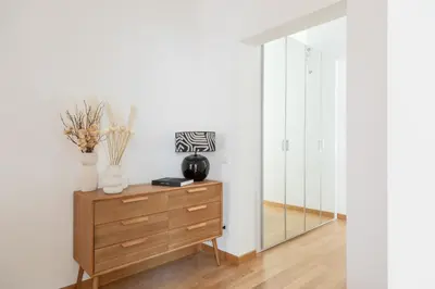 a dressing room with a dresser and a mirror at Barberini Caesar Suites in Rome