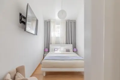 a small bedroom with a bed and a couch at Barberini Caesar Suites in Rome