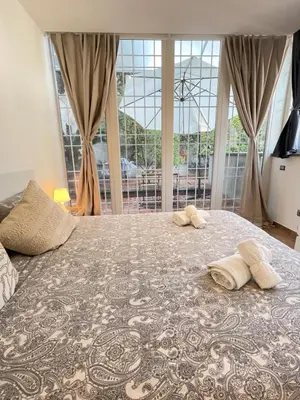 a bedroom with a large bed with two pillows on it at Green Home in Rome