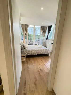 a bedroom with a bed and a large window at Green Home in Rome