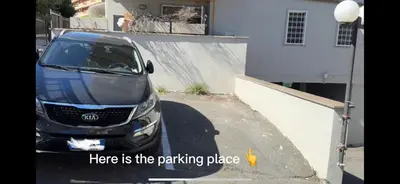a car parked in a parking lot next to a building at Green Home in Rome