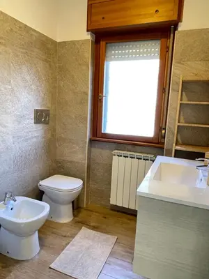 a bathroom with a toilet and a sink and a tub at Green Home in Rome