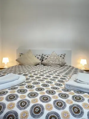 a bed with two pillows on top of it at Green Home in Rome