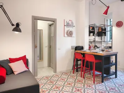 a living room with a table and red chairs at Cortile al Vaticano by Bed&Bros in Rome