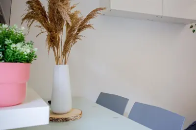 a white table and chairs in a room with a window at Holiday Homes Rome - Portuense 21 - Studio with little private Garden in Rome