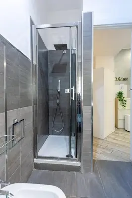 a shower with a glass door in a bathroom at Holiday Homes Rome - Portuense 21 - Studio with little private Garden in Rome