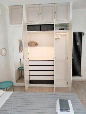 a bedroom with a closet with white cabinets at Il Cortile - Appartamento nel cuore di Testaccio in Rome
