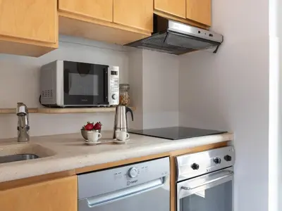 a kitchen with a sink and a microwave at The Best Rent - Two-bedroom apartment with terrace near Trevi Fountain in Rome